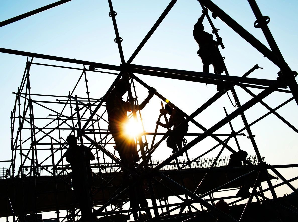 A group of men working on scaffolding.